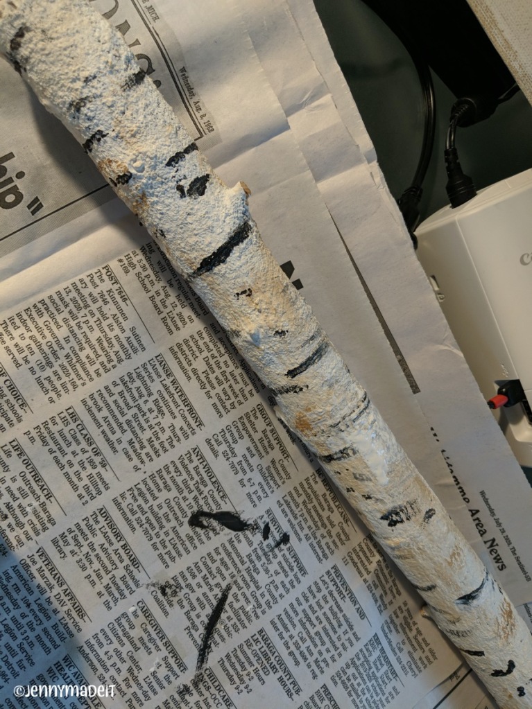 Photo of one branch painted to resemble a birch log