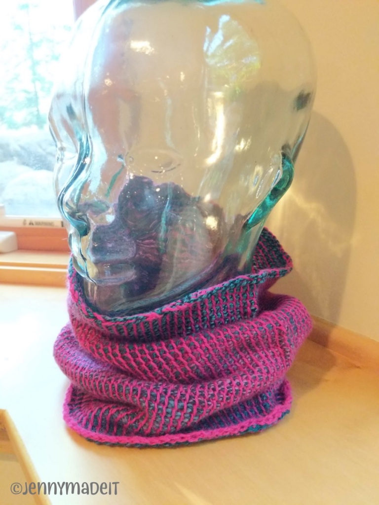 This is a photo of a glass head and neck displaying a Tunisian crochet cowl I made.